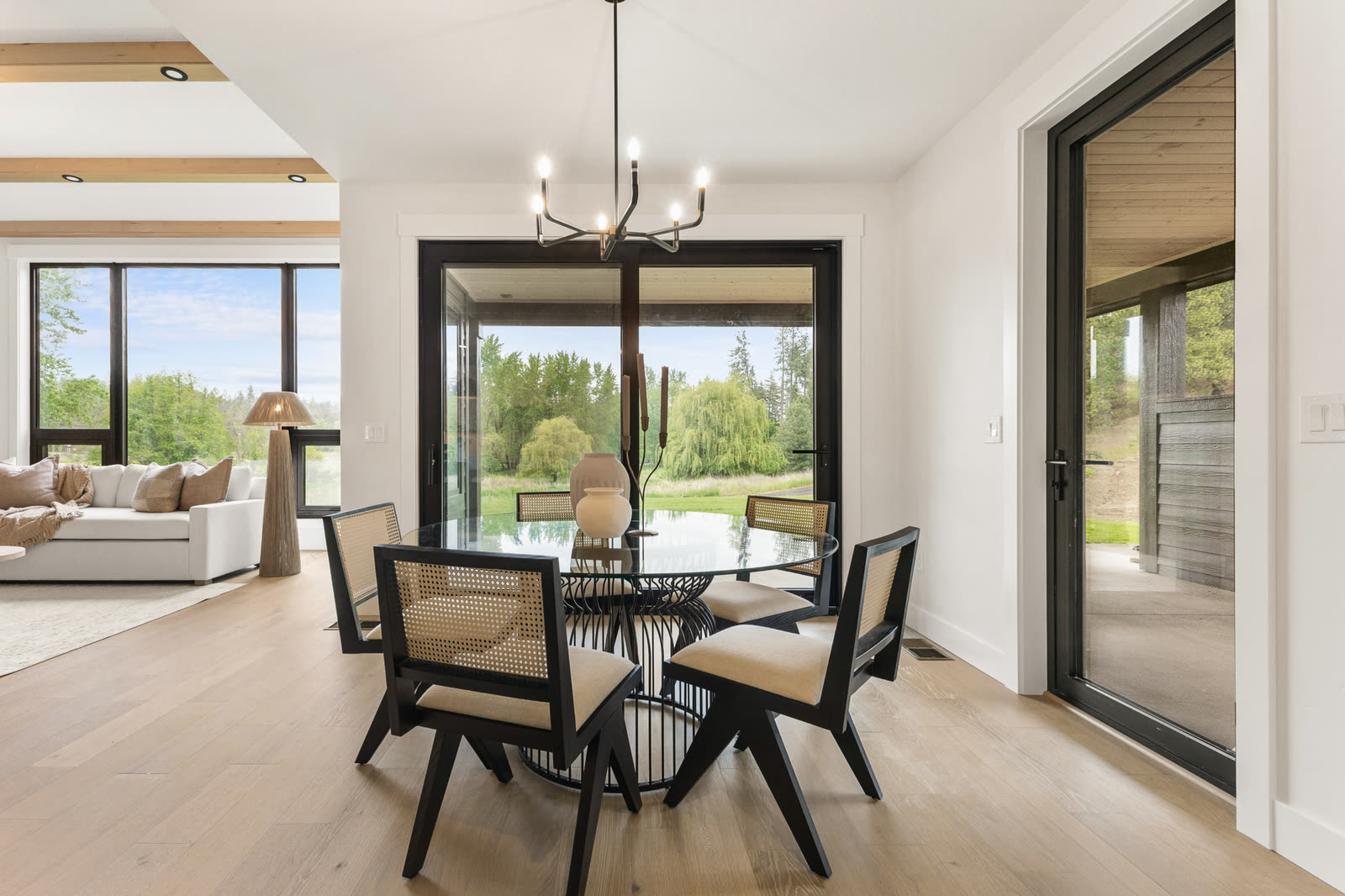 Dining room framed by tall black-trimmed windows