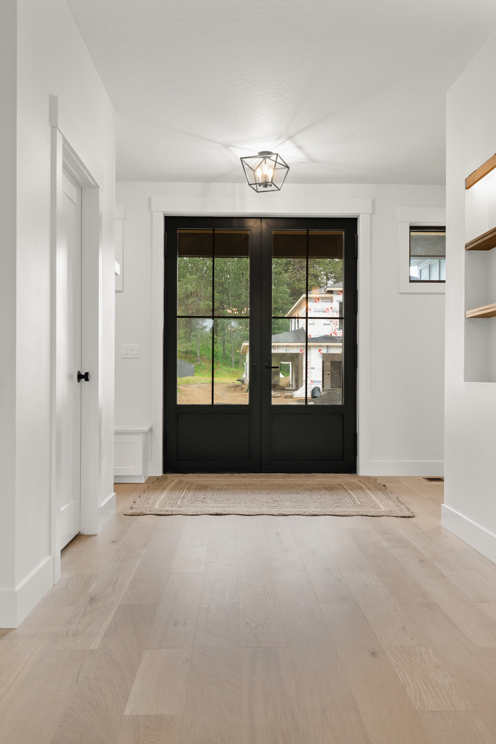 Black double entry doors under a covered porch