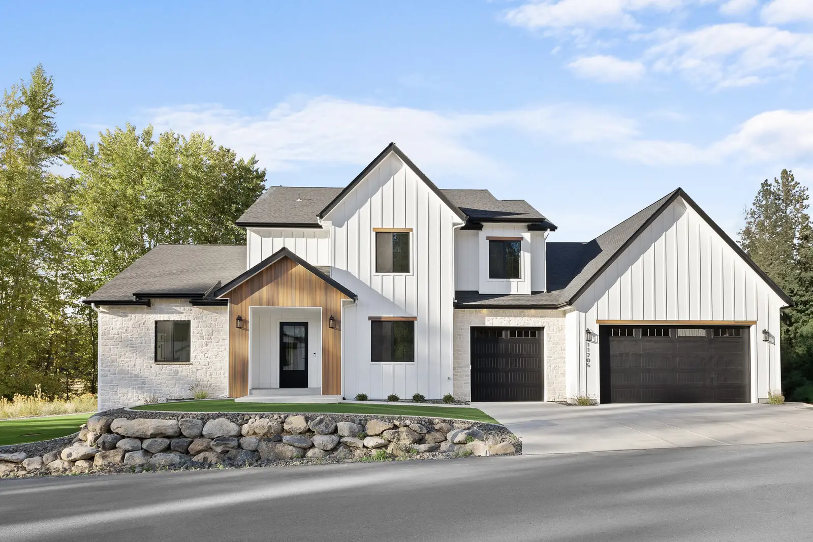 Custom farmhouse exterior with a long drive