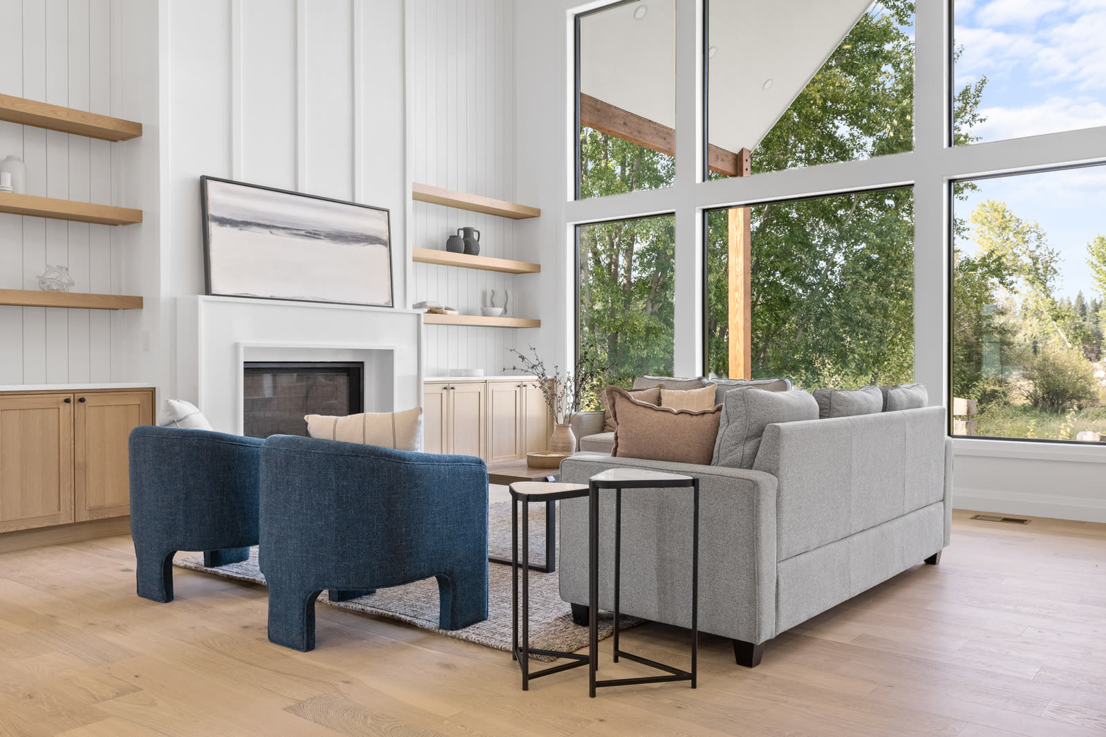 Great room with tall windows overlooking the property
