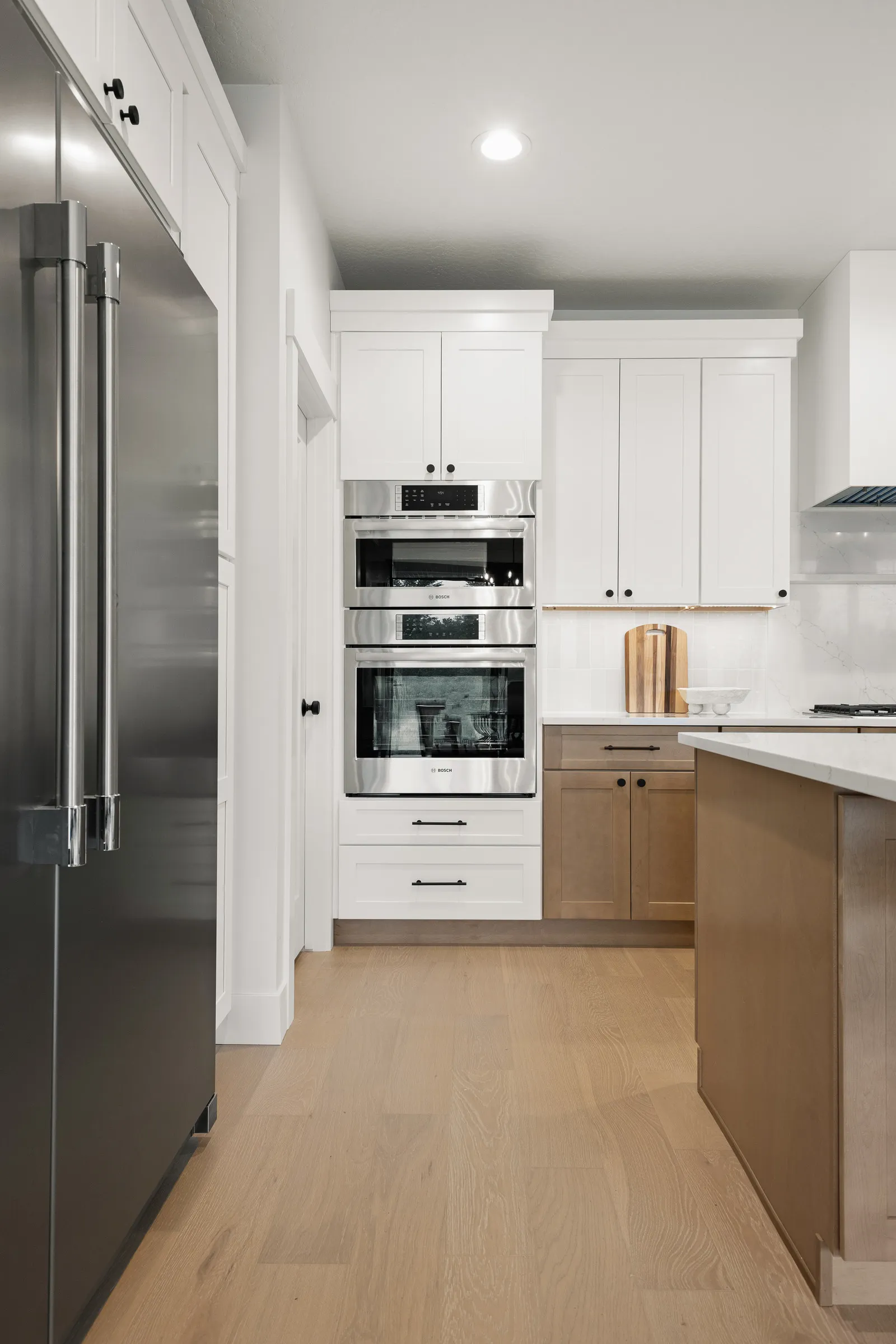 White oak kitchen cabinetry with wall ovens